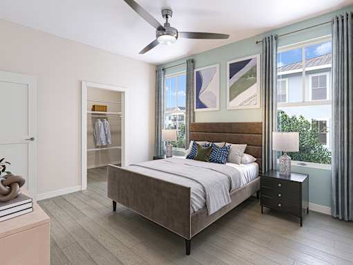 A bedroom with a bed, nightstand, and a ceiling fan.