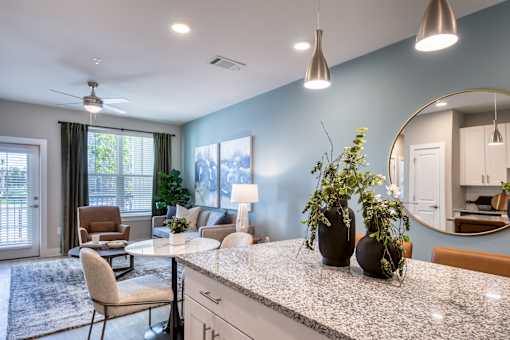 A kitchen with a table and chairs and a fan.