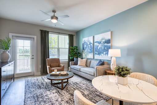A living room with a white table and a brown chair.