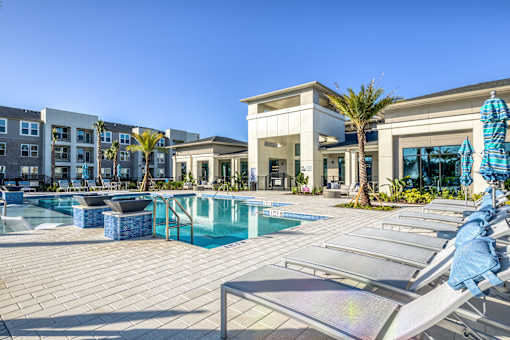 A sunny day at the poolside with a clear blue sky.