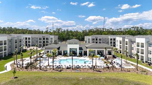 A large building complex with a pool in the middle.