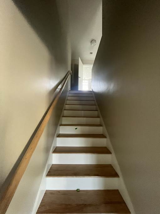 A long flight of stairs with a light at the top.