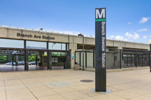 a sign that says branch ave station in front of a building