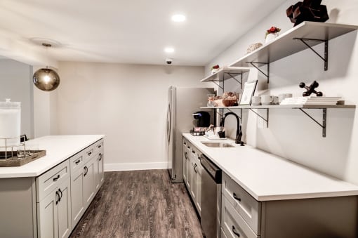 a kitchen with white countertops and stainless steel appliances at Hamilton at Kings Place, Maryland