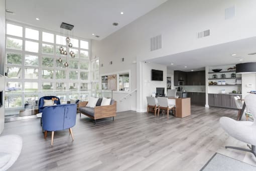 a living room filled with furniture and a large window at Madison at Eden Brook, Maryland, 21046