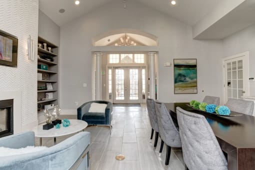 an open concept living room and dining room with a fireplace and a large table and chairs at Ellicott Grove, Ellicott City Maryland