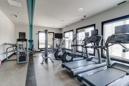 a gym with treadmills and other exercise equipment  at Ellicott Grove, Ellicott City, MD 21043