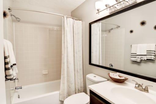 a bathroom with a shower toilet and sink at Hamilton at Kings Place, Columbia City