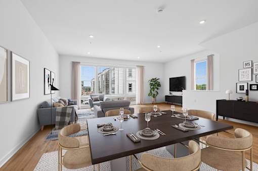A modern dining room with a large table set for six.