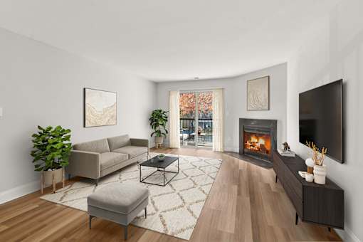 A living room with a fireplace and a couch  at Poplar Glen Apartments, Columbia, MD, 21044.