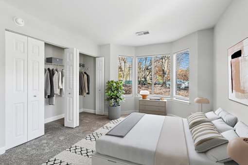 A bedroom with a large bed and a wardrobe at Poplar Glen Apartments, Columbia, MD, 21044.