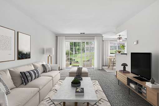 Spacious living room with patio access at The Brook At Columbia Apartments, Maryland, 21044