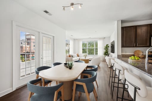 a living room and kitchen with a dining table and chairs at Aspire Apollo, Camp Springs