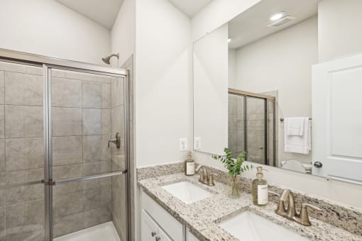 a bathroom with two sinks and a shower at Refinery Row, Baltimore, Maryland, 21224