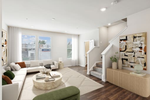 a living room with a white couch and a staircase at Refinery Row, MD 21224