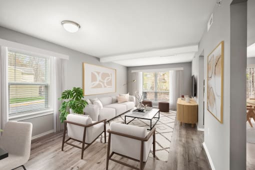 a living room with a white couch and chairs at Villages at Morgan Metro, Landover, 20785