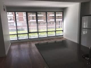 A room with a large window overlooking a building.