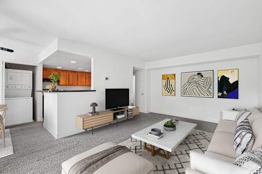 Modern living room with wood media console at The Brook At Columbia Apartments, Columbia, MD 21044