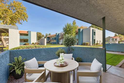 A patio with a table and chairs under a roof at Riviera Park, Chandler Arizona