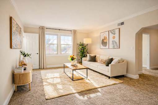 A living room with a white couch, a coffee table, and a rug ighland Ridge Apartments, Capitol Heights, MD, 20743