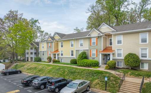 Apartment complex with a parking lot in front at Ellicott Grove, Ellicott City, MD 21043