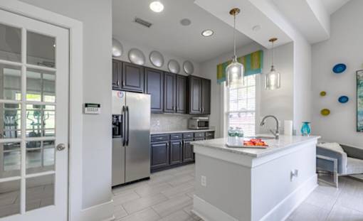 A kitchen with a white island and stainless steel appliances at Ellicott Grove, Ellicott City, MD 21043