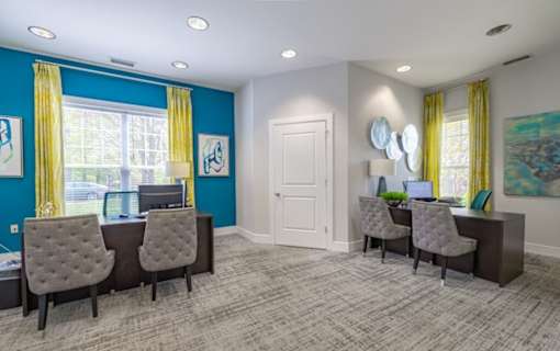A room with two desks and chairs, one of which has a laptop on it at Ellicott Grove, Ellicott City, MD 21043