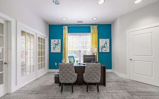 Two grey chairs are in front of a desk with a computer on it at Ellicott Grove, Ellicott City, MD 21043