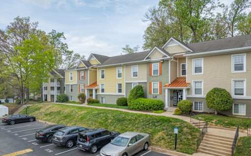 Apartment complex with a parking lot in front at Ellicott Grove, Ellicott City, MD 21043