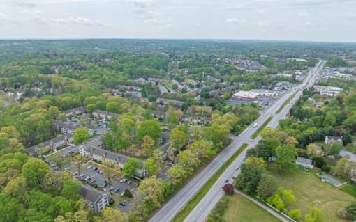 A bird's eye view of a residential area with a road running through it at Ellicott Grove, Ellicott City, MD 21043