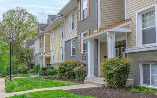 A row of houses with green lawns in front at Ellicott Grove, Ellicott City, MD 21043