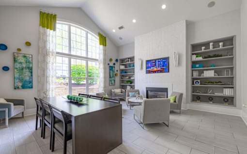 A modern kitchen with a large island and a TV mounted on the wall at Ellicott Grove, Ellicott City, MD 21043