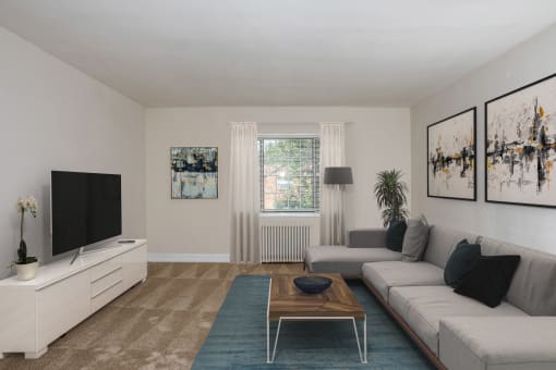 a living room with a couch and a coffee table at Hamilton Manor Apartments, Maryland, 20782