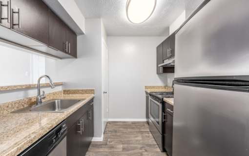A kitchen with a sink, stove, and refrigerator at Madison at Eden Brook, 21046