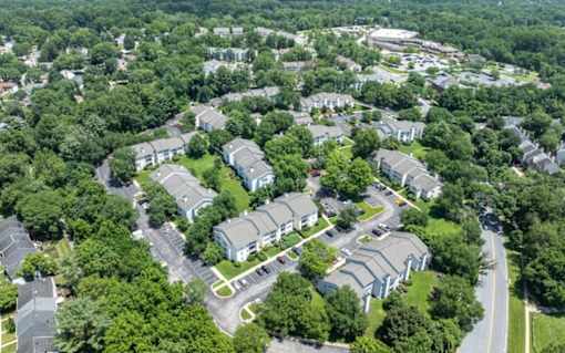 A bird's eye view of a residential area with houses and trees at Madison at Eden Brook, 21046