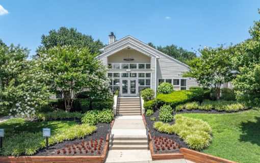 A house with a front yard and a set of stairs leading to the front door at Madison at Eden Brook, 21046