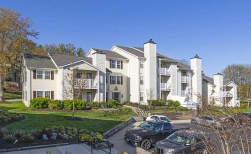 A row of townhouses with cars parked in front at Madison at Eden Brook, 21046