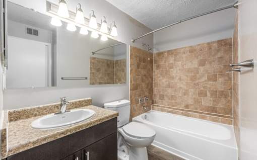 A bathroom with a sink, toilet, and bathtub at Madison at Eden Brook, 21046