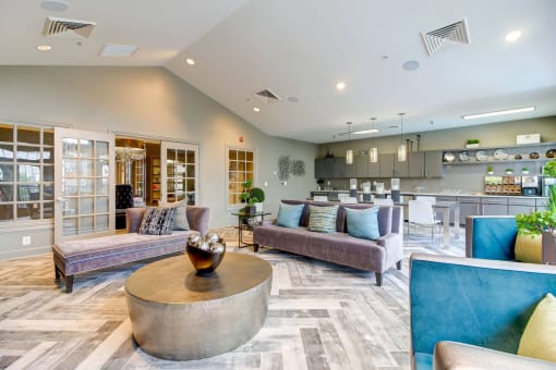 a living room with couches and a table at MetroPlace at Town Center, Camp Springs, MD