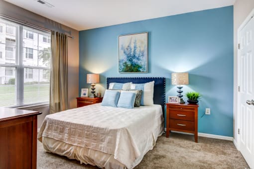 a bedroom with a bed and two night stands at MetroPlace at Town Center, Camp Springs, Maryland