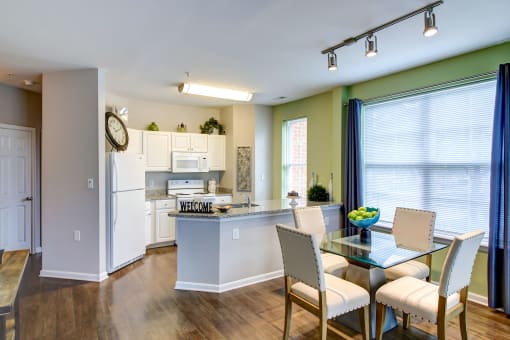 an open kitchen and dining room with a table and chairs at MetroPlace at Town Center, Maryland, 20746