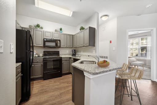 a kitchen with stainless steel appliances and granite counter tops at MetroPlace at Town Center, Camp Springs, 20746