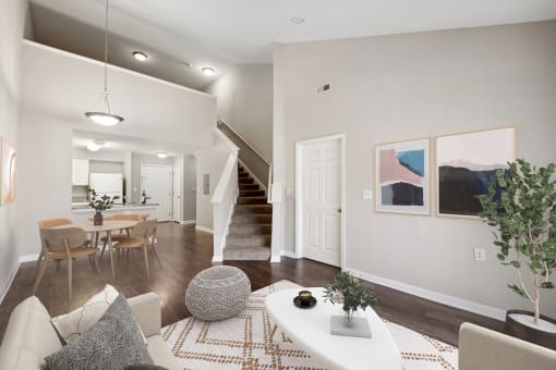 an open living room and dining room with a staircase in a home at MetroPlace at Town Center, Maryland