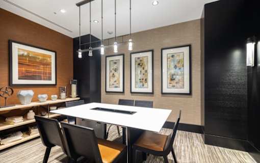 A modern dining room with a white table and black chairs at Mira Upper Rock, Maryland, 20850