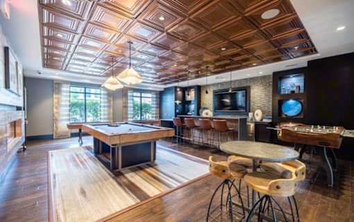 A room with a pool table and a bar area at Mira Upper Rock, Maryland, 20850
