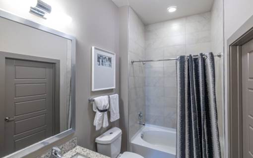 A bathroom with a toilet, sink, and shower at Mira Upper Rock, Maryland, 20850