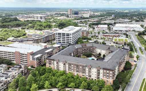 A large building complex with a parking garage in front at Mira Upper Rock, Maryland, 20850