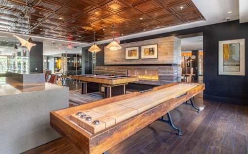 A room with a wooden table and bench in the foreground at Mira Upper Rock, Maryland, 20850