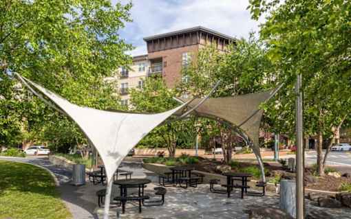 A park with a white canopy and picnic tables at Mira Upper Rock, Maryland, 20850