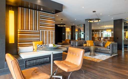 A modern living room with a striped wall and a fireplace at Mira Upper Rock, Maryland, 20850
